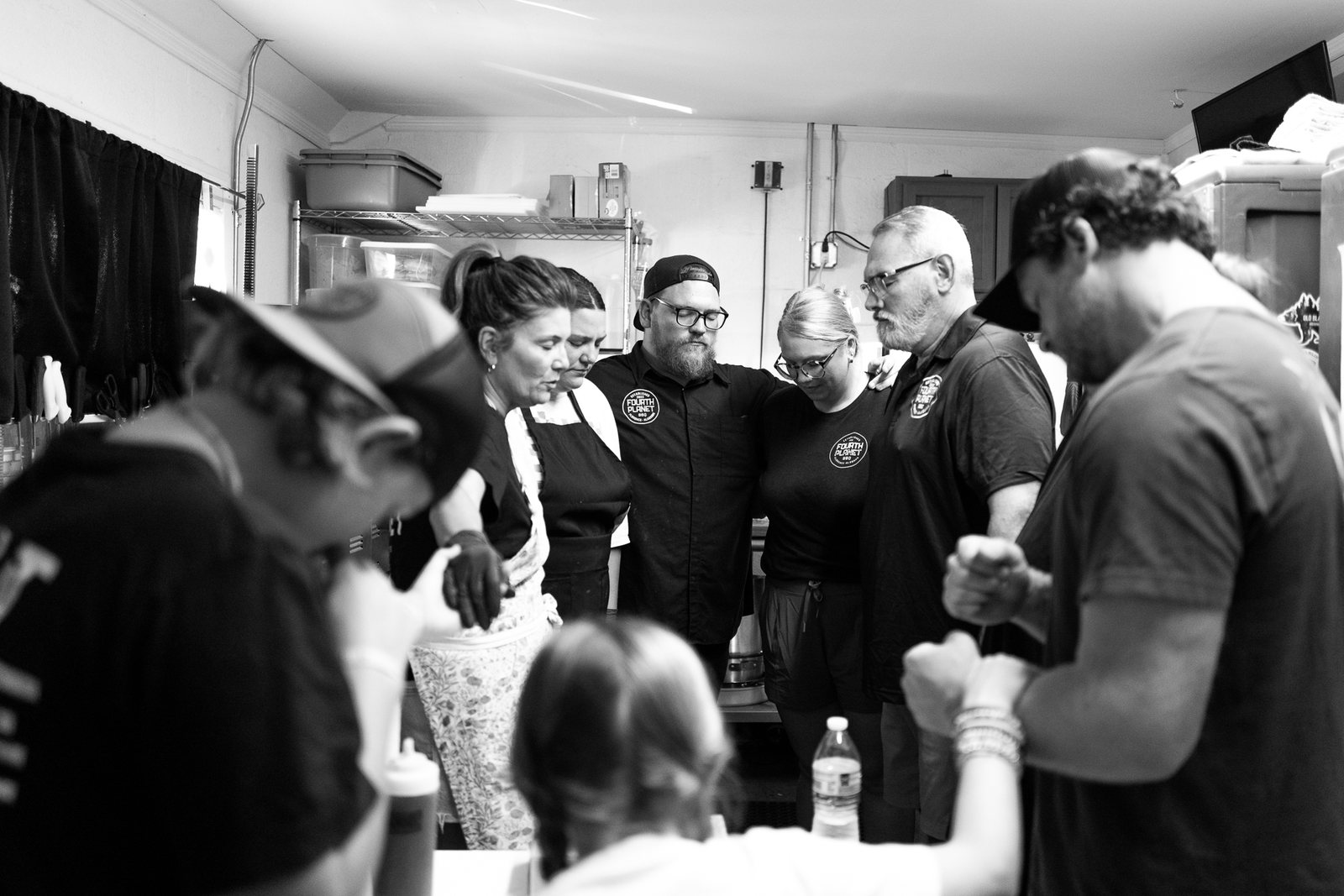 The Fourth Planet BBQ team gathered in prayer before service